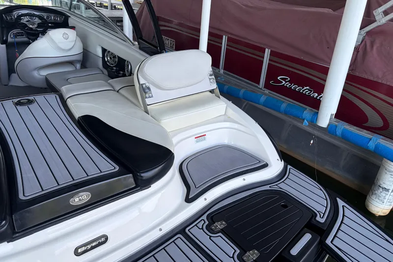 Slide: The Image of 2013 Bryant 210 Walkabout boat interior with sleek seating and modern dashboard. - 10