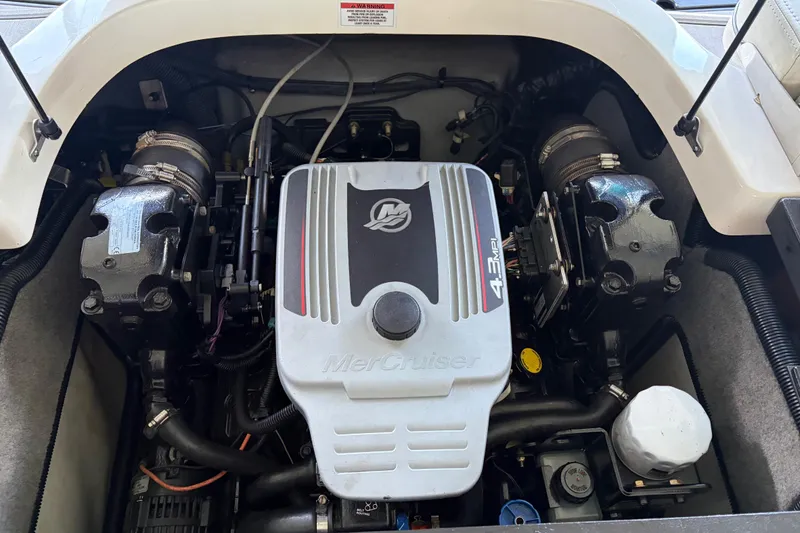 Slide: The Image of Engine compartment of a 2013 Bryant 210 Walkabout boat featuring a MerCruiser 4.3 MPI engine. - 12