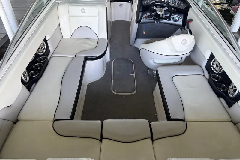 Slide: The Image of Interior of a 2013 Bryant 210 Walkabout boat with white seating and steering console. - 2