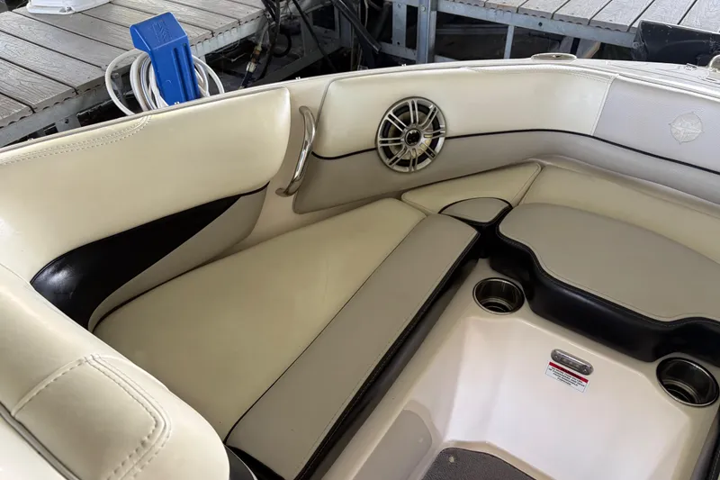 Slide: The Image of Interior seating of a 2013 Bryant 210 Walkabout boat with cup holders and speaker. - 3