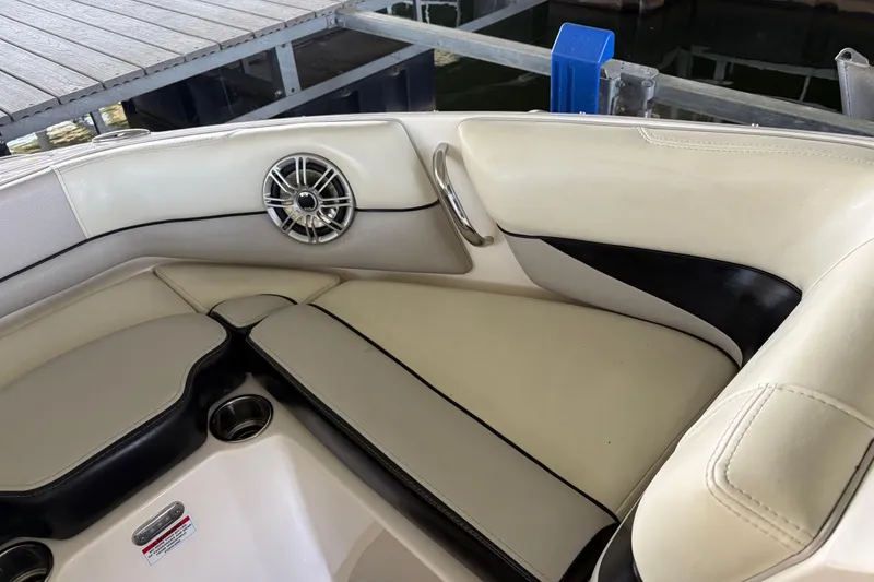 Slide: The Image of Interior seating of a 2013 Bryant 210 Walkabout boat with speaker and cup holders. - 4