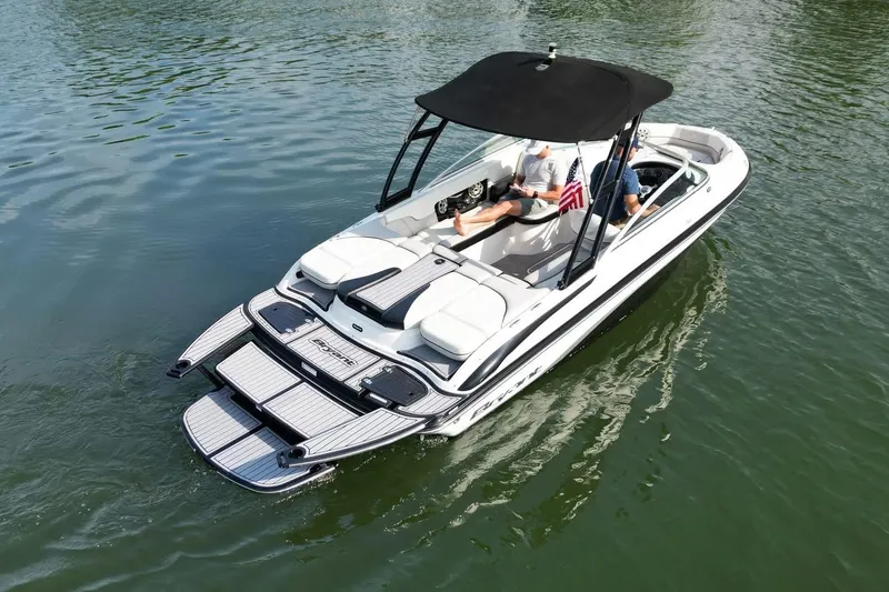 Slide: The Image of 2013 Bryant 210 Walkabout boat on water, featuring sleek design and comfortable seating. - 6
