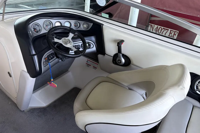 Slide: The Image of Steering console of a 2013 Bryant 210 Walkabout boat with gauges and controls. - 5
