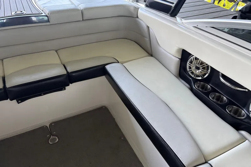 Slide: The Image of Interior seating of a 2013 Bryant 210 Walkabout boat with cup holders and speaker. - 7