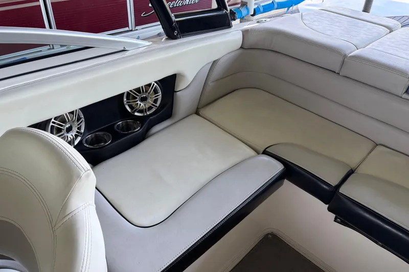Slide: The Image of Interior seating of a 2013 Bryant 210 Walkabout boat with cup holders and speakers. - 8