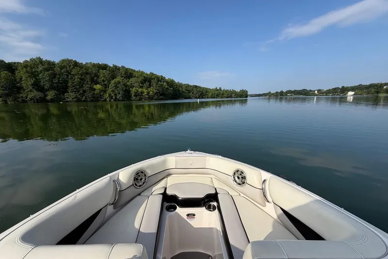 Slide: The Image of Bow view of a 2013 Bryant 210 Walkabout boat on a serene lake. - 11