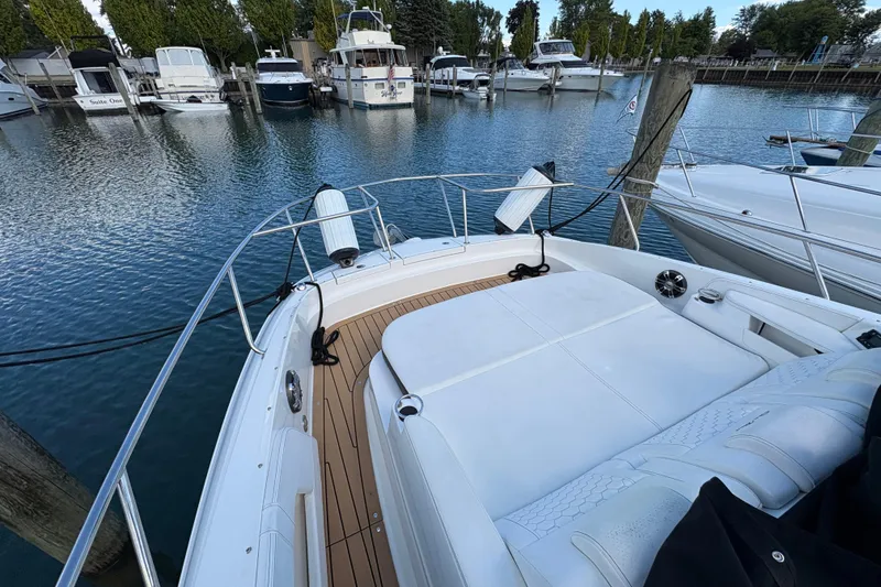 Slide: The Image of 2019 Sea Ray Sundancer 320 docked at marina, featuring spacious deck and sleek design. - 10