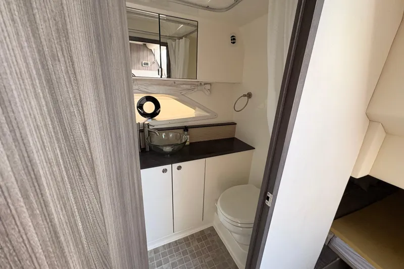 Slide: The Image of 2019 Sea Ray Sundancer 320 bathroom with modern fixtures and compact design. - 12