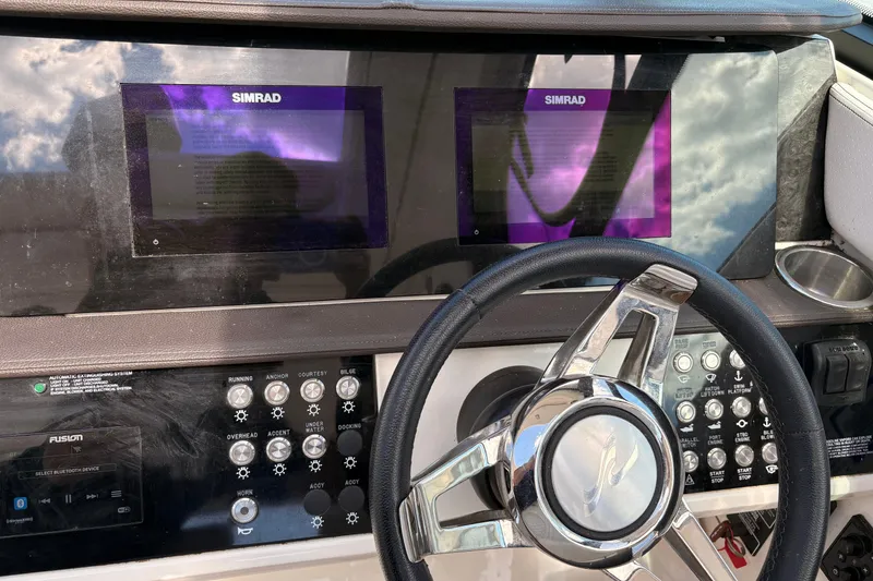 Slide: The Image of Control panel of a 2019 Sea Ray Sundancer 320 with Simrad displays and steering wheel. - 18