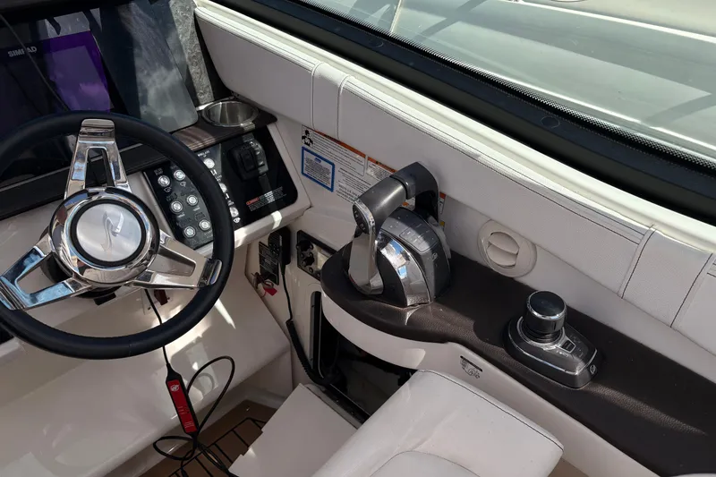 Slide: The Image of 2019 Sea Ray Sundancer 320 helm with steering wheel and control panel. - 20
