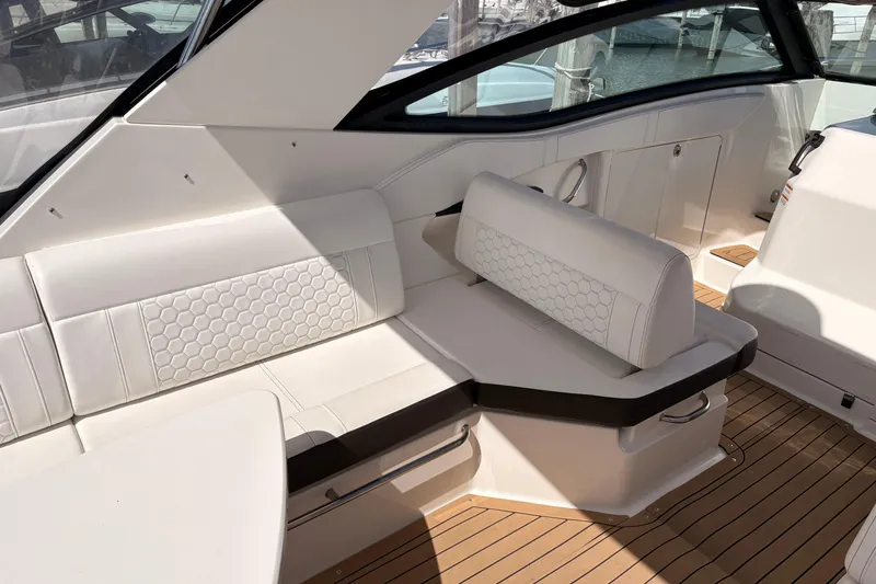 Slide: The Image of Luxurious interior of 2019 Sea Ray Sundancer 320 with white seating and wood flooring. - 6