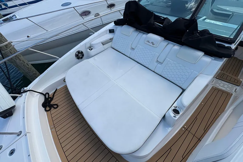 Slide: The Image of 2019 Sea Ray Sundancer 320 boat with white seating and teak flooring. - 2