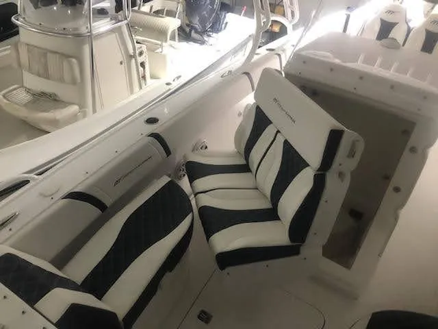 Slide: The Image of 2019 Midnight Express 39 Cuddy boat interior with cushioned seating and sleek design. - 11