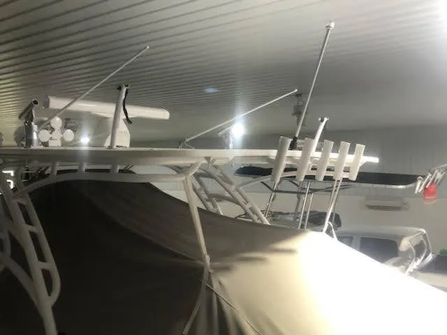 Slide: The Image of 2019 Midnight Express 39 Cuddy boat stored indoors, covered and equipped with antennas. - 18