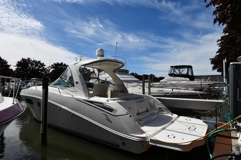 The Image of 2008 Sea Ray Sundancer 350 yacht docked at marina under blue sky. - 1