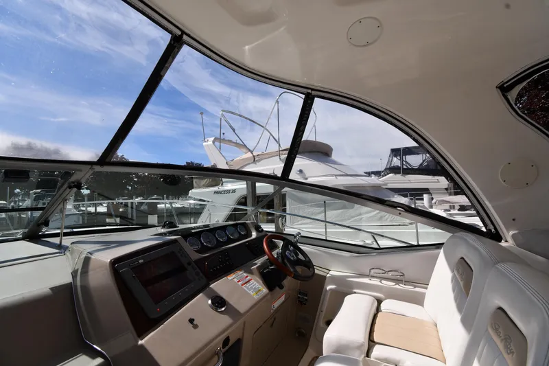 Slide: The Image of Interior view of a 2008 Sea Ray Sundancer 350 yacht cockpit with steering wheel and dashboard. - 11