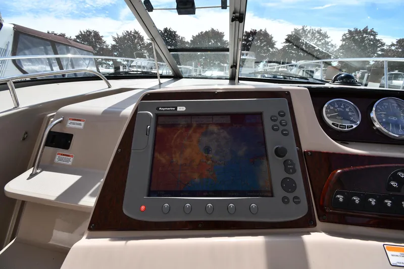 Slide: The Image of 2008 Sea Ray Sundancer 350 dashboard with navigation system and gauges. - 12