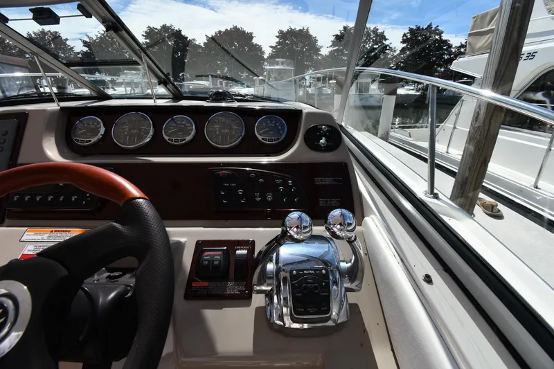 Slide: The Image of Cockpit view of 2008 Sea Ray Sundancer 350 with steering wheel and control panel. - 13