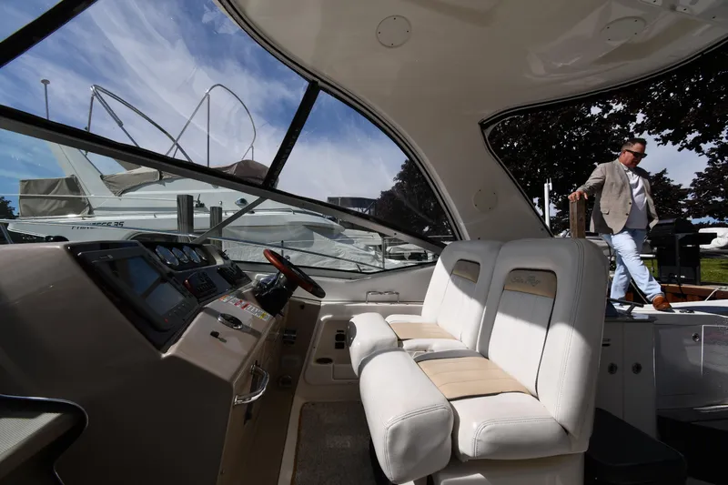 Slide: The Image of Interior view of 2008 Sea Ray Sundancer 350 yacht with man stepping aboard. - 14