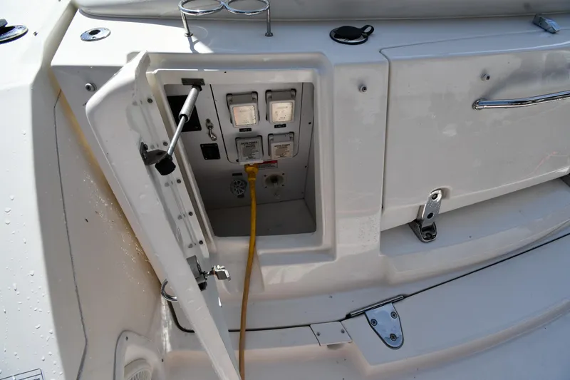 Slide: The Image of Electrical panel on a 2008 Sea Ray Sundancer 350 boat with open access door. - 18