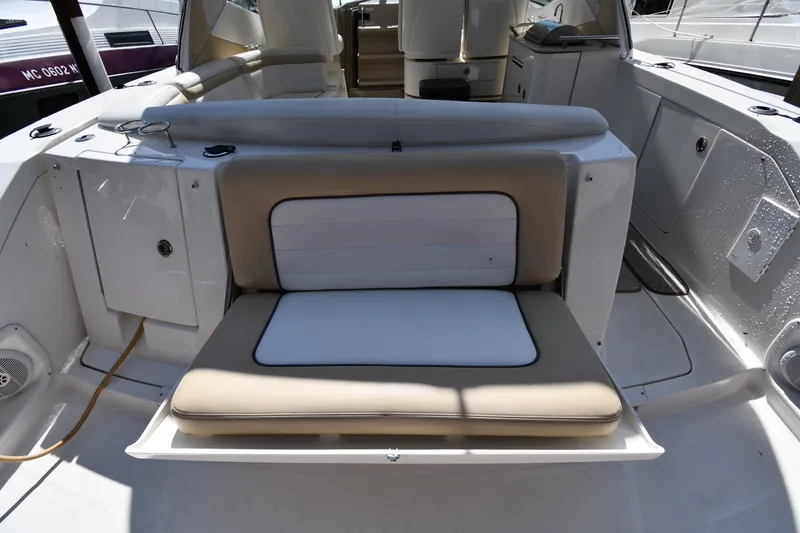 Slide: The Image of 2008 Sea Ray Sundancer 350 boat interior with cushioned seating and storage compartments. - 19