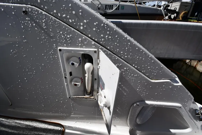 Slide: The Image of 2008 Sea Ray Sundancer 350 boat with open water hose compartment. - 20