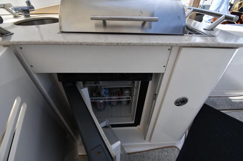 Slide: The Image of Outdoor kitchenette on a 2008 Sea Ray Sundancer 350 yacht with a mini fridge and grill. - 23