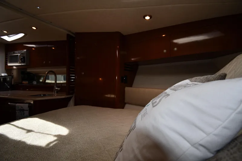 Slide: The Image of Interior of 2008 Sea Ray Sundancer 350 yacht with cozy bed and kitchenette. - 29