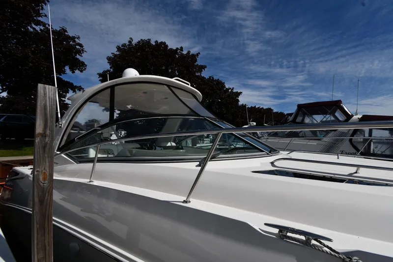 Slide: The Image of 2008 Sea Ray Sundancer 350 yacht docked under a clear blue sky. - 3