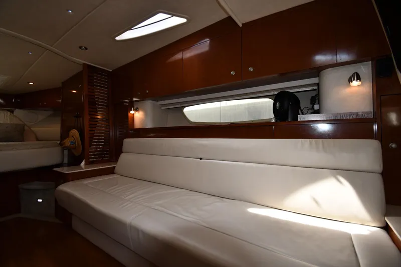 Slide: The Image of Interior of 2008 Sea Ray Sundancer 350 yacht with white leather seating and wooden cabinetry. - 31