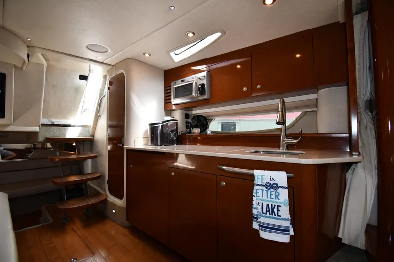 Slide: The Image of Interior of 2008 Sea Ray Sundancer 350 yacht kitchen with wooden cabinetry and modern appliances. - 33