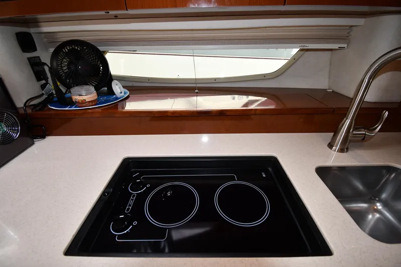 Slide: The Image of Modern kitchen area in a 2008 Sea Ray Sundancer 350 yacht with stovetop and sink. - 36