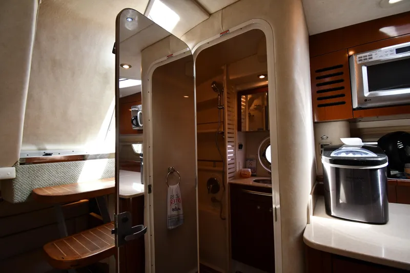 Slide: The Image of Interior of 2008 Sea Ray Sundancer 350 yacht, featuring kitchenette and bathroom area. - 39