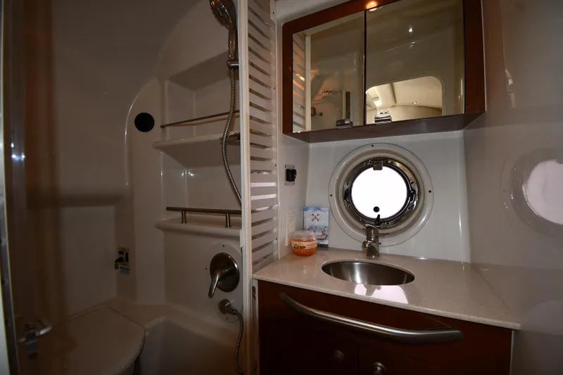 Slide: The Image of Luxurious bathroom in 2008 Sea Ray Sundancer 350 yacht with sink, mirror, and porthole window. - 40