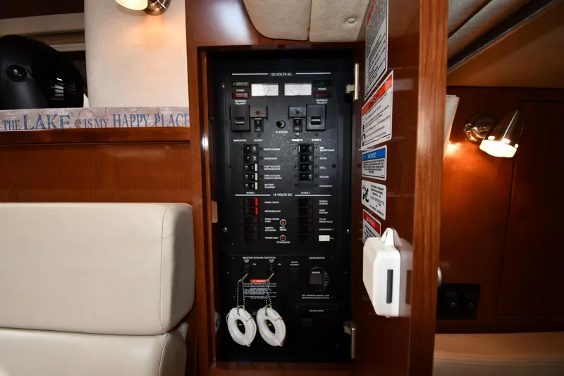 Slide: The Image of Electrical panel inside 2008 Sea Ray Sundancer 350 yacht cabin, featuring control switches and labels. - 45
