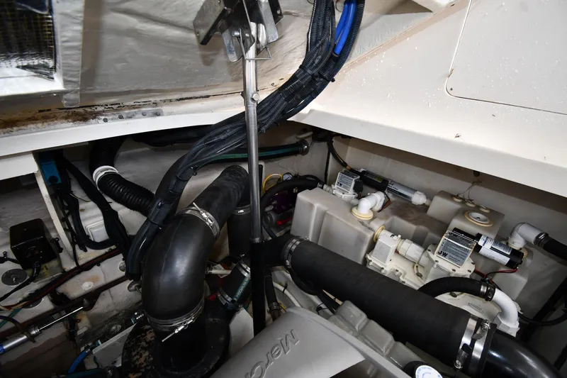 Slide: The Image of Engine compartment of 2008 Sea Ray Sundancer 350, showcasing hoses and mechanical components. - 51