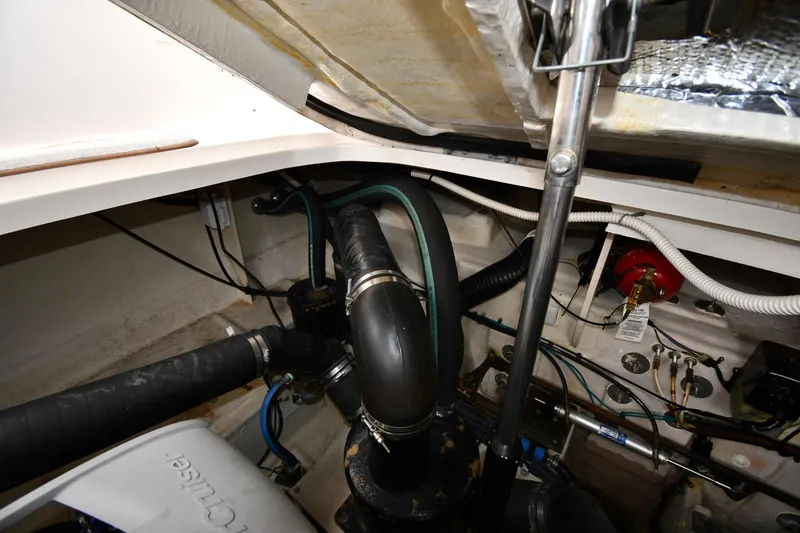 Slide: The Image of Engine compartment of a 2008 Sea Ray Sundancer 350 with visible hoses and wiring. - 52