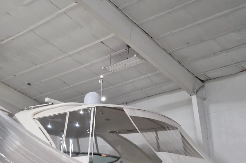 Slide: The Image of Sea Ray Sundancer 540 yacht, 2000 model, stored indoors under a high ceiling. - 18