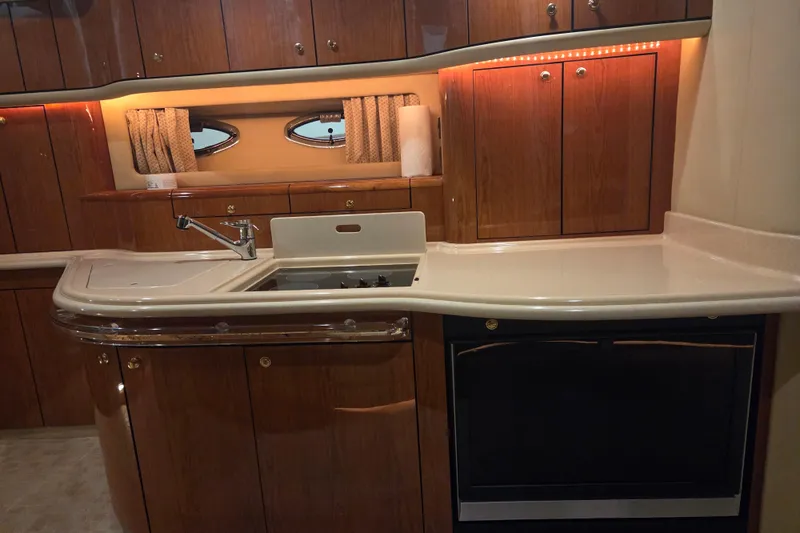 Slide: The Image of Luxurious kitchen interior of 2000 Sea Ray Sundancer 540 yacht with wood cabinetry. - 23