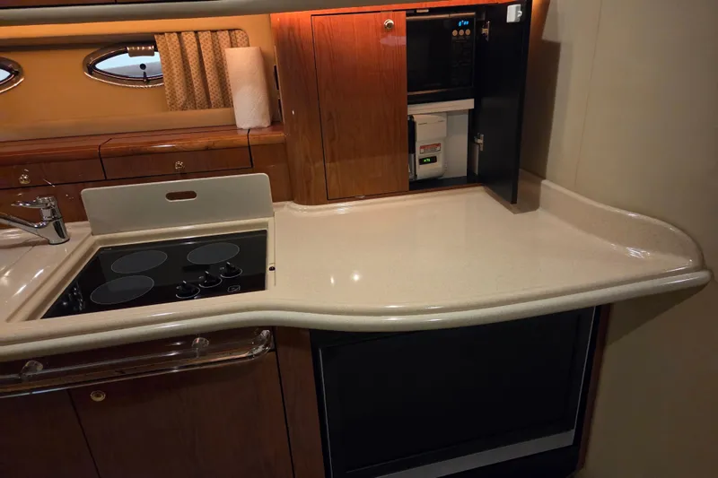 Slide: The Image of Kitchen area of a 2000 Sea Ray Sundancer 540 yacht with stove and countertop. - 26