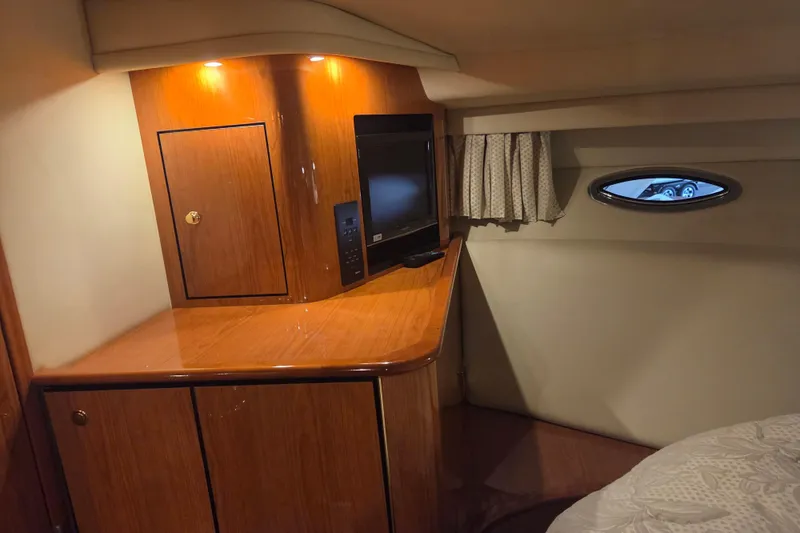 Slide: The Image of Interior of 2000 Sea Ray Sundancer 540 yacht with wood cabinetry and TV. - 30