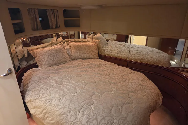 Slide: The Image of Luxurious bedroom interior of 2000 Sea Ray Sundancer 540 yacht with elegant bedding. - 31