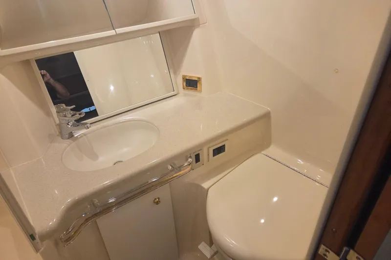Slide: The Image of Bathroom interior of 2000 Sea Ray Sundancer 540 yacht, featuring sink and toilet. - 33
