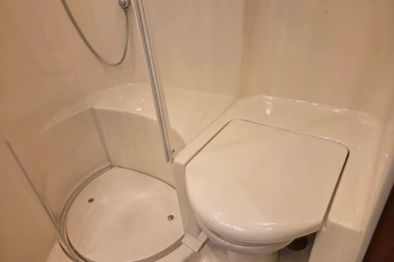 Slide: The Image of Bathroom interior of 2000 Sea Ray Sundancer 540 yacht, featuring shower and toilet. - 38