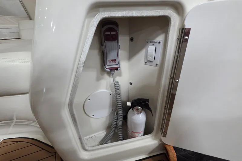 Slide: The Image of Storage compartment on a 2000 Sea Ray Sundancer 540 yacht with control panel and fire extinguisher. - 52