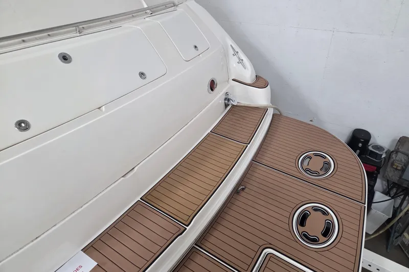 Slide: The Image of 2000 Sea Ray Sundancer 540 swim platform with teak decking in a garage setting. - 60
