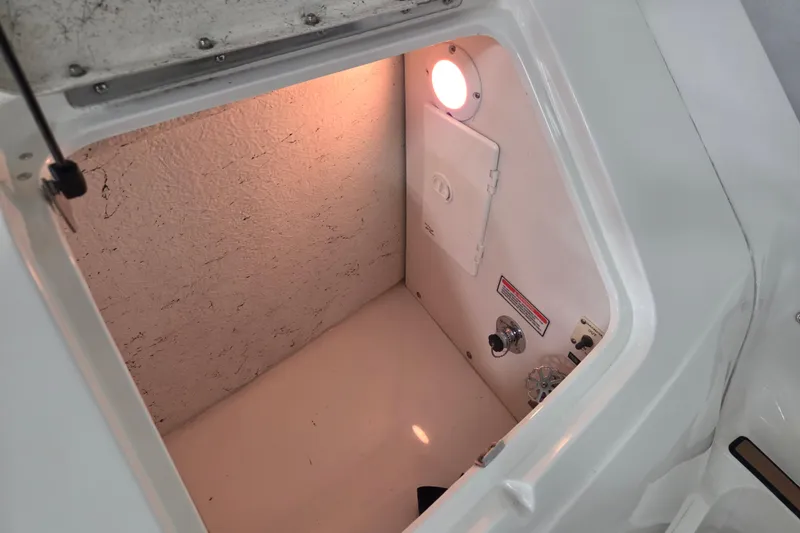 Slide: The Image of Storage compartment inside a 2000 Sea Ray Sundancer 540 boat, featuring a light and control panel. - 62