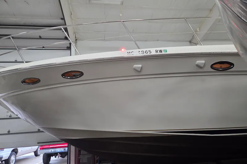 Slide: The Image of 2000 Sea Ray Sundancer 540 yacht in a garage, showcasing its sleek hull design. - 68