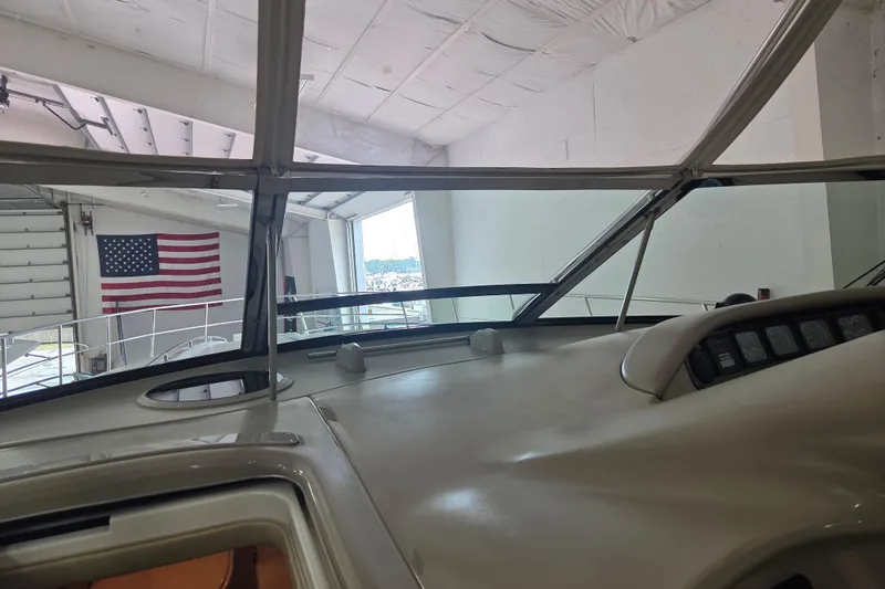 Slide: The Image of Interior view of 2000 Sea Ray Sundancer 540 yacht in a marina with American flag. - 69