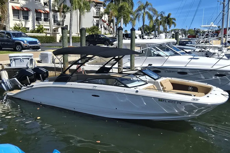 The Image of 2024 Sea Ray SDX 290 Outboard boat docked in a sunny marina setting. - 0